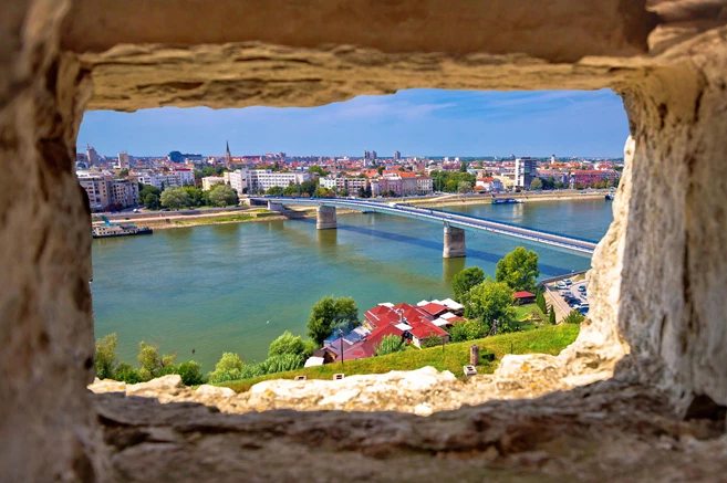 City Of Novi Sad and Danube river aerial view through stone window from Petrovaradin