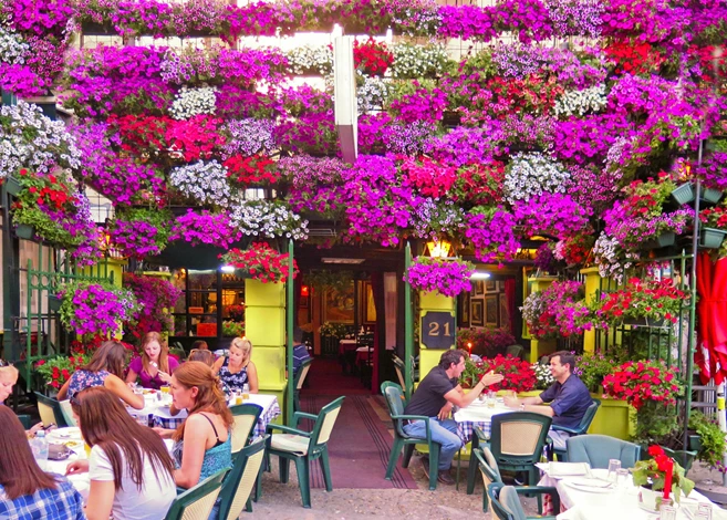 ourists enjoy in restaurant outside garden tables in Skandarlija