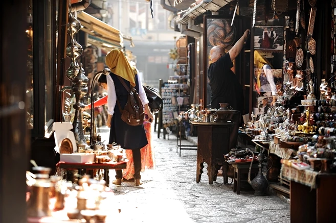 Tourists looking at souvenirs in old Sarajevo bazaar